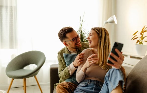 excited-couple-relax-on-couch-feel-euphoric-win-lo-2021-09-01-15-58-10-utc(1)